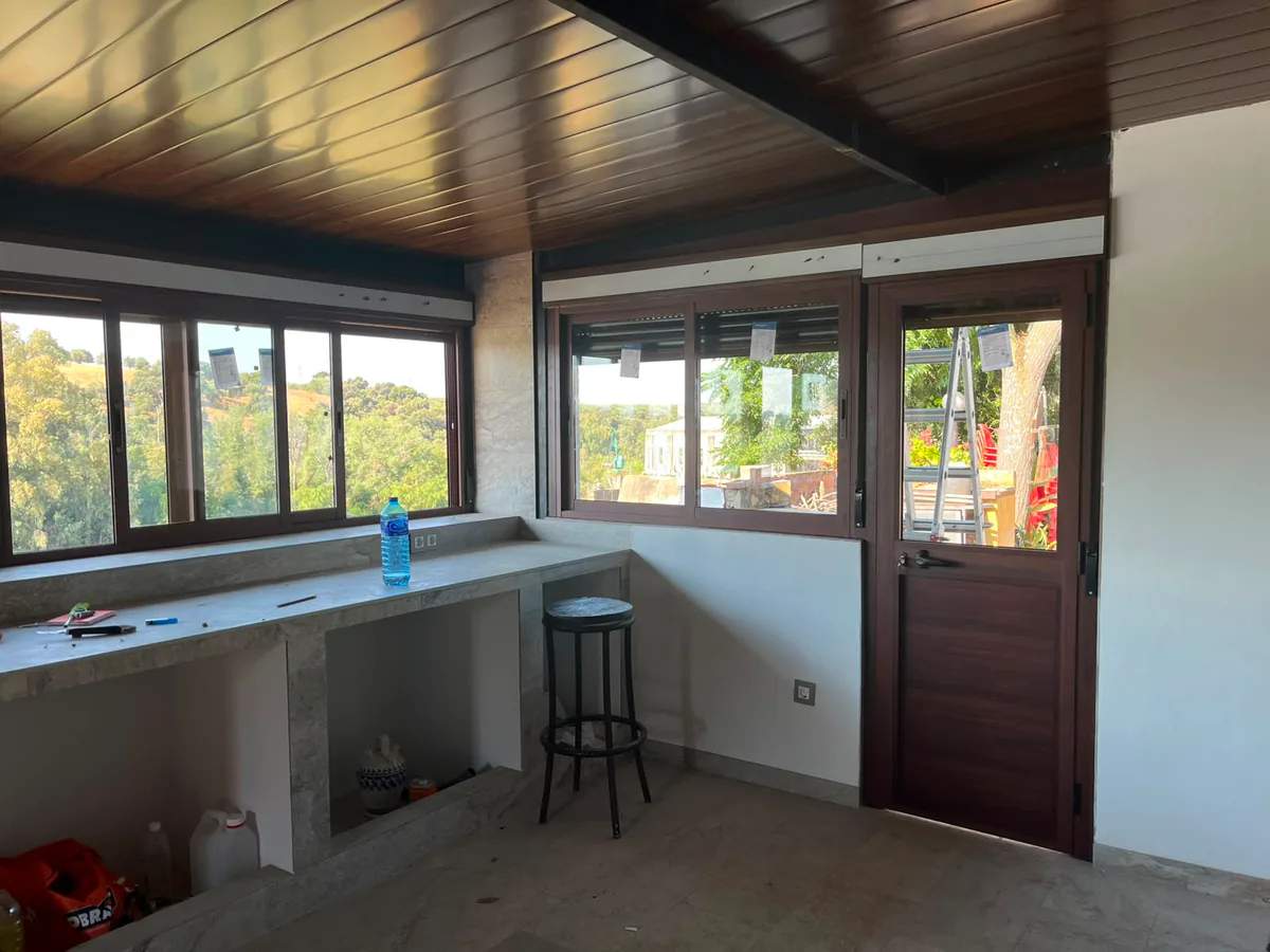 Ventanas de aluminio imitación madera resueltas en esquina, con cajón de persiana integrado — METALISUR Málaga